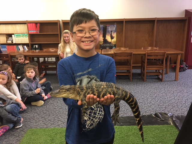 student holding a reptile